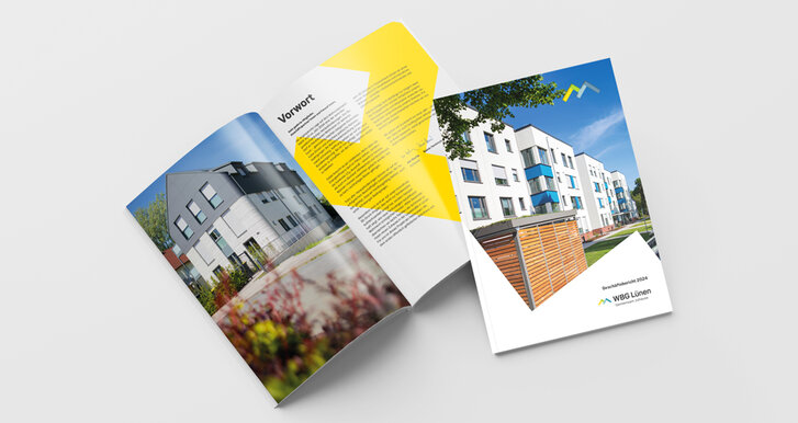 Aufgeschlagener Geschäftsbericht (2024) der WBG Lünen mit Fotos von Wohngebäuden und Seiten mit Text.