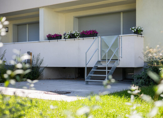 Neu angelegter Mieter*innengarten, der über eine Treppe vom Balkon im Erdgeschoss erreichbar ist.